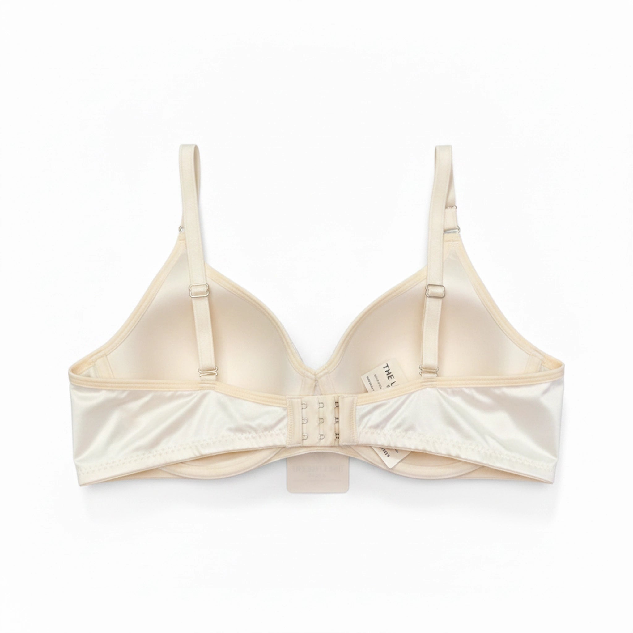 Back view of the off-white quilted bra showing the adjustable hook-and-eye closure and wide comfortable band.