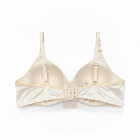 Back view of the off-white quilted bra showing the adjustable hook-and-eye closure and wide comfortable band.