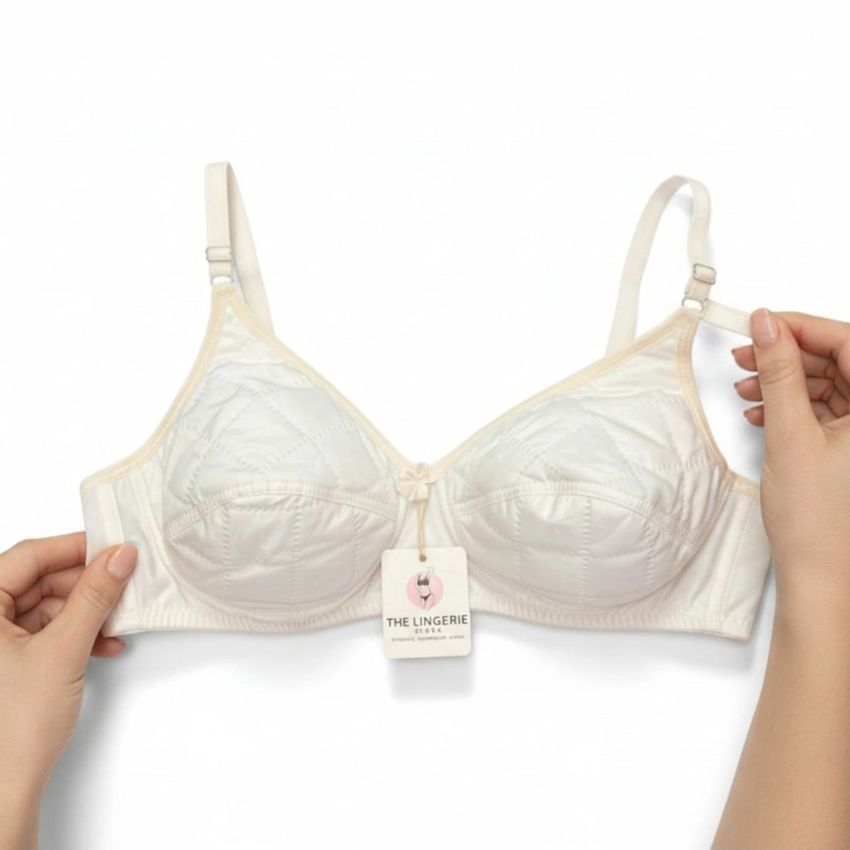 Back view of the off-white quilted bra showing the adjustable hook-and-eye closure and wide comfortable band.