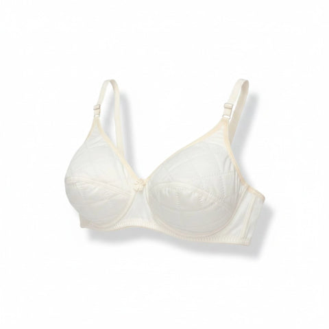 Side angle view of the off-white quilted bra showcasing the seamless side wings and comfortable underarm fit.